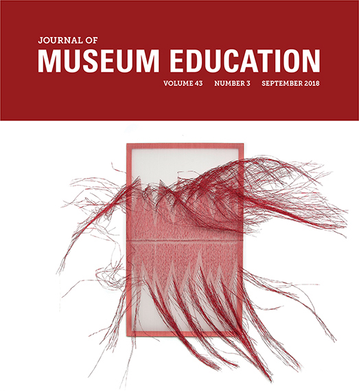 Cover of the September 2018 edition of the Journal of Museum Education. Title in is red and white, with an image of red and grey tapestry with many threads unraveling.